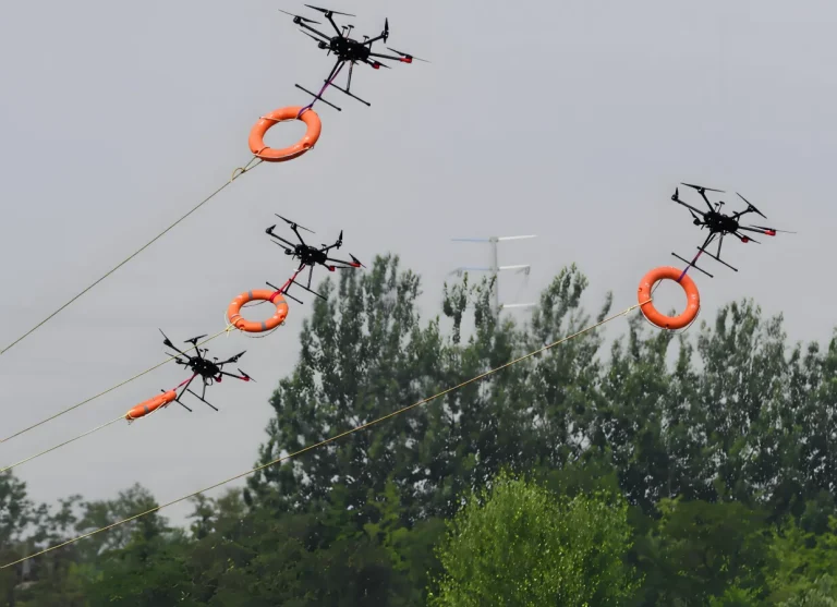Rescue drones carrying lifebuoys over the water