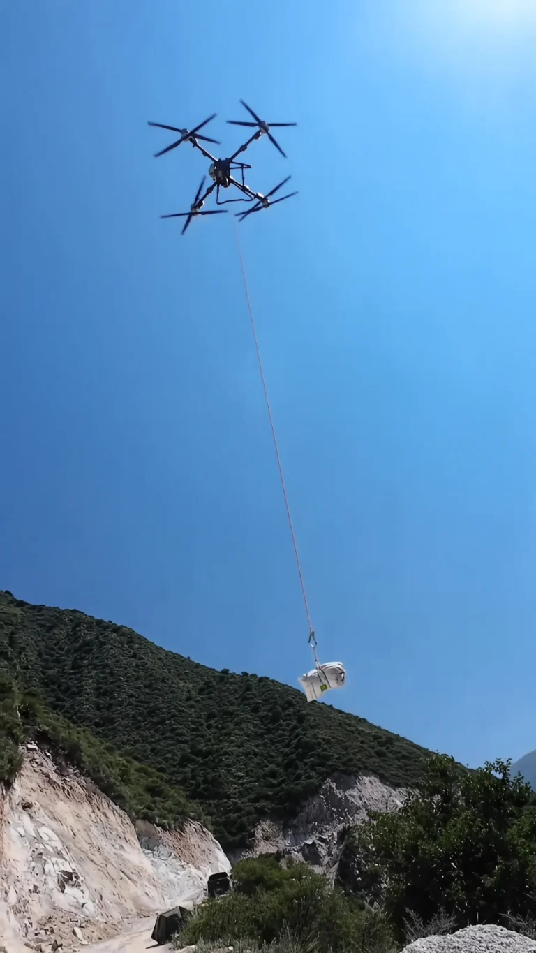 Heavy-lift drone lifting cargo up a mountain slope