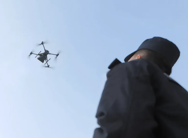 Security officer watching a patrol drone